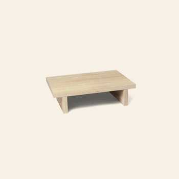 The ferm LIVING Kona Side Table by ferm LIVING is a small, rectangular side table with wide legs and a Japanese-inspired design, crafted from FSC-certified oak veneer. It’s shown on a plain off-white background.