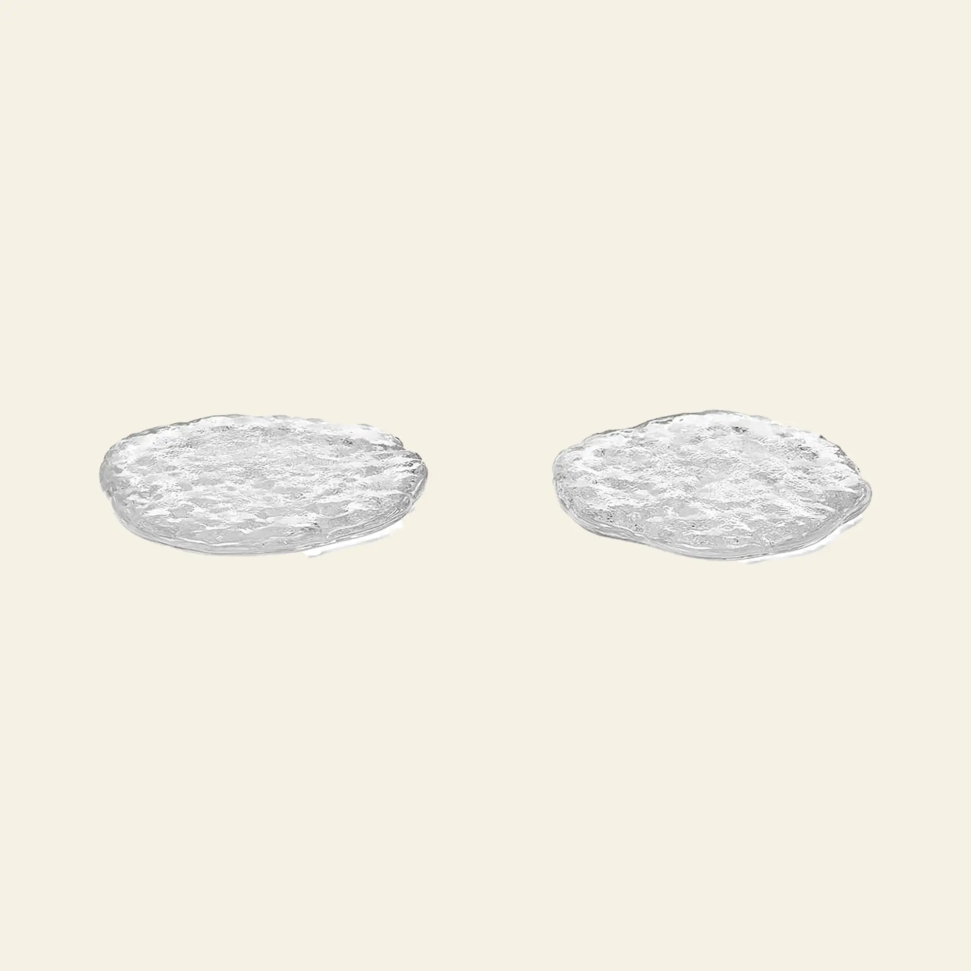 The ferm LIVING Momento Glass Stones S, Set of 2 by ferm LIVING are elegantly displayed side by side on a plain, light beige background, evoking a sophisticated touch reminiscent of decorative glass stones.