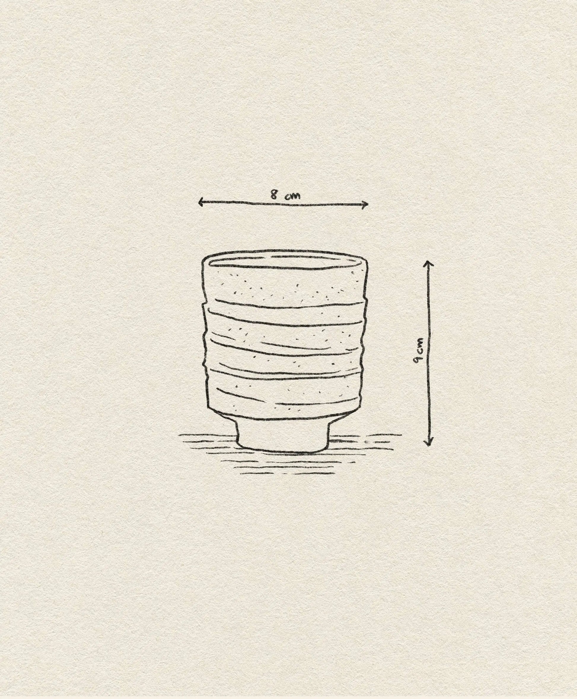 A hand-drawn illustration of the ferm LIVING Serena Cup by ferm LIVING shows its handcrafted clay form with horizontal ridges, measuring 8 cm wide and 9 cm tall. Arrows indicate dimensions, while the textured surface highlights a reactive glaze finish.