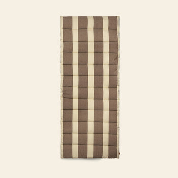 The ferm LIVING Strand Quilted Mattress, rectangular and padded, features a brown and beige plaid pattern in organic cotton, displayed against a plain light background.