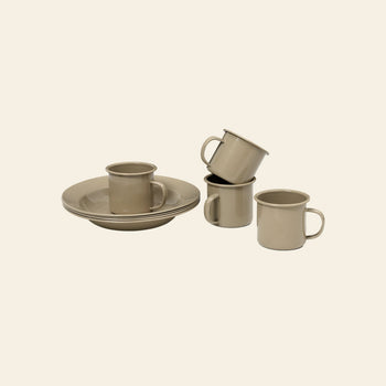 The ferm LIVING Yard Picnic, Set of 8 by ferm LIVING features four beige ceramic cups with handles and two matching plates, elegantly stacked on a plain background—a perfect minimalist set for stylish and functional outdoor dining.