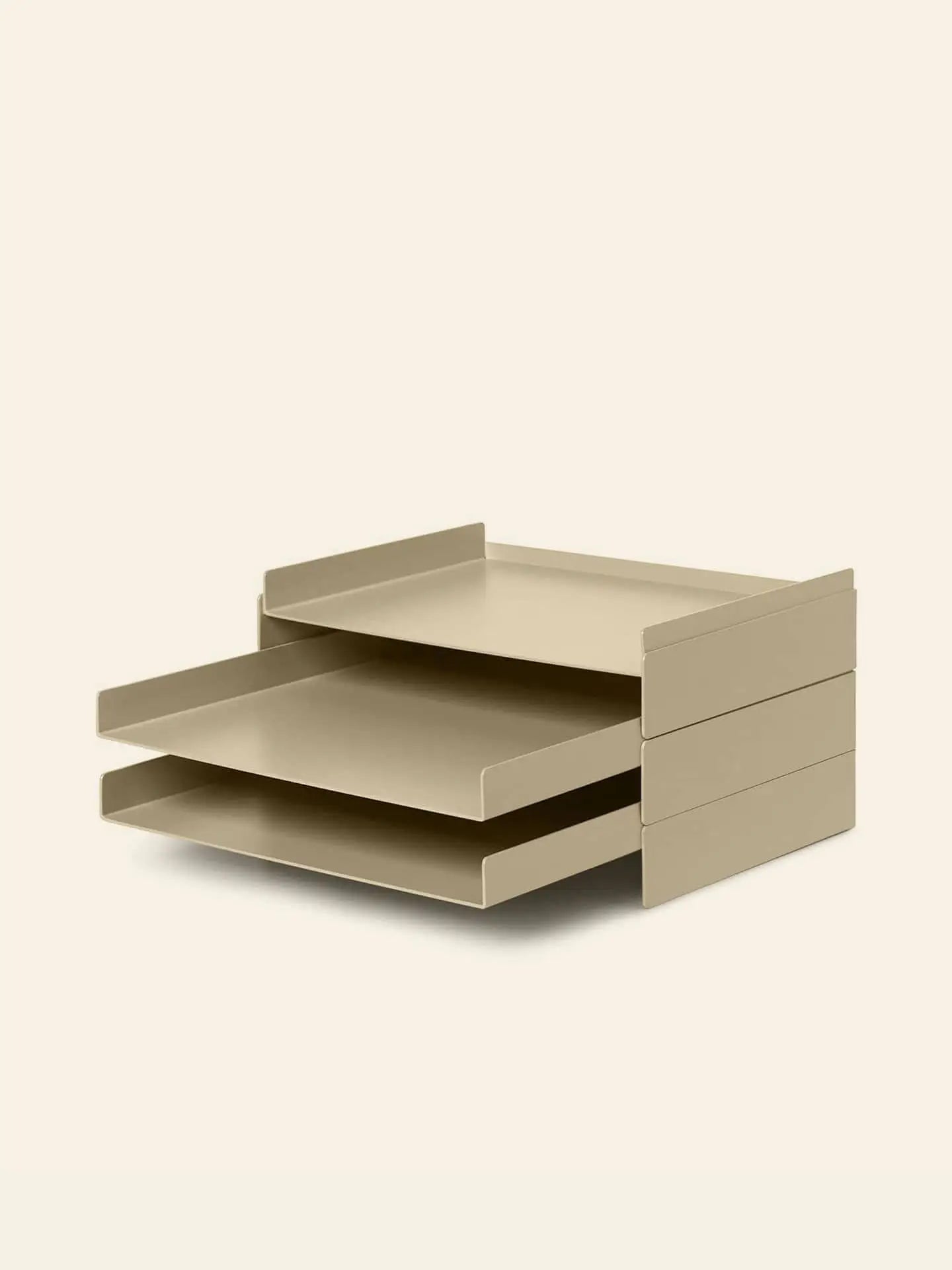 The ferm LIVING 2x2 Organizer is a beige, two-tiered metal desk accessory with a minimalist look. Shown on a light background, its stacked trays pull out to keep your workspace organized and free of clutter.