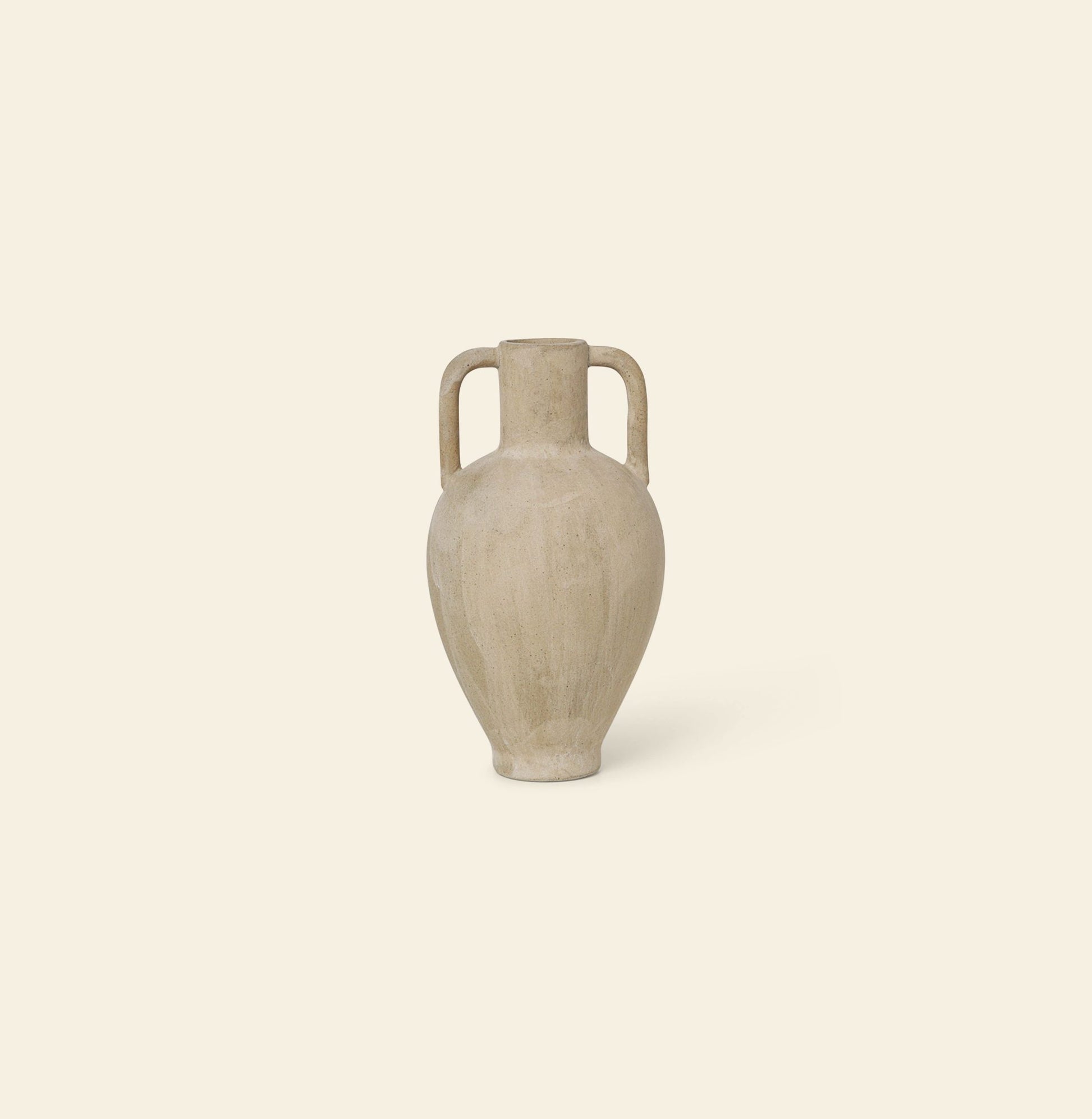 The ferm LIVING Ary Mini Vase L, a beige stoneware vase with two handles and a subtle textured glaze inspired by ancient Greek vases, sits centered against an off-white background.