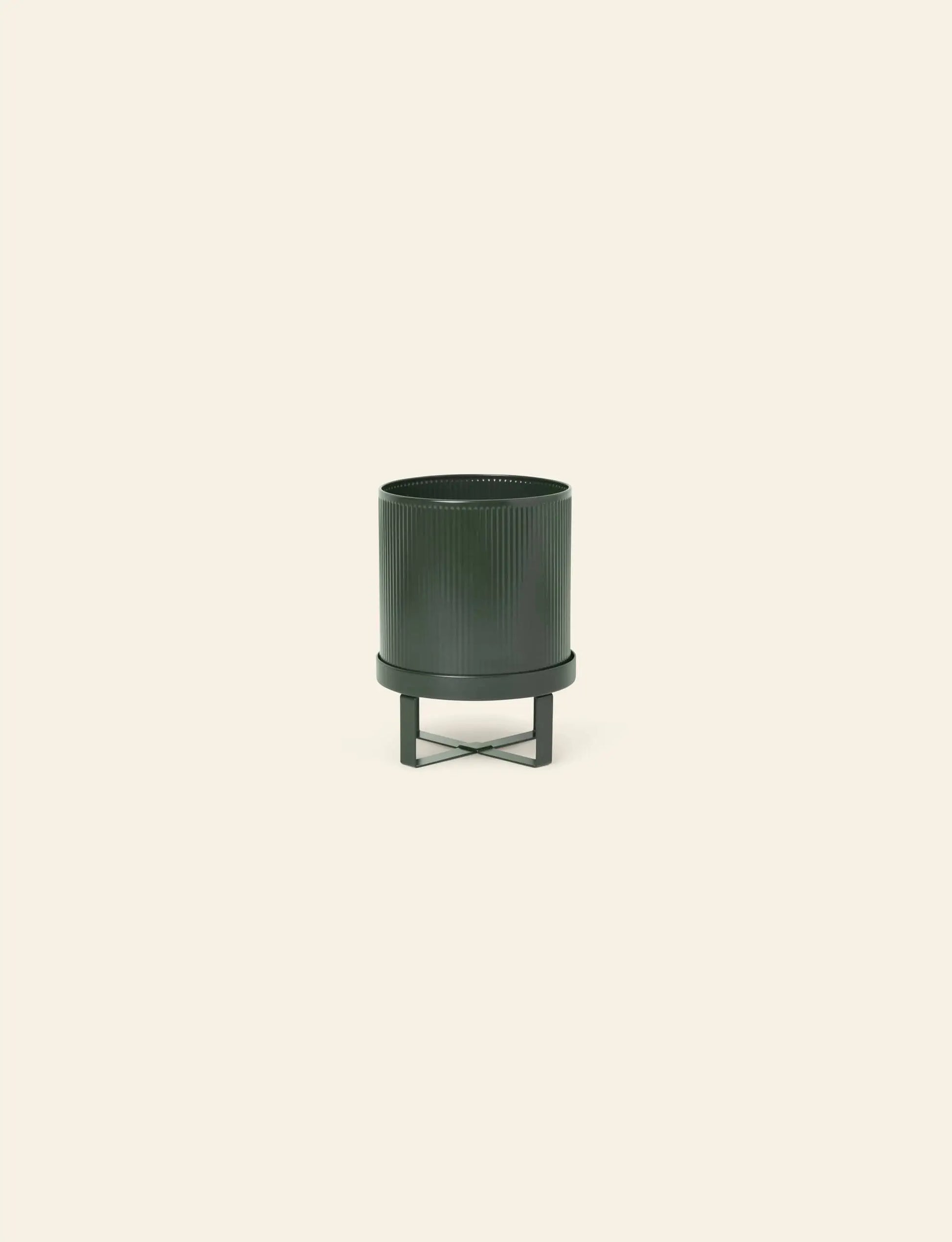 The ferm LIVING Bau Pot, Small, is a dark green ribbed cylindrical planter with a matching stand by ferm LIVING, displayed on a plain light beige background.