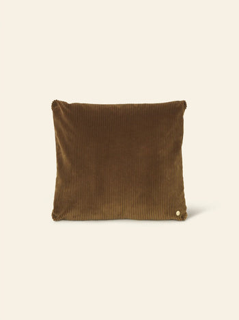 The ferm LIVING Corduroy Cushion is a rectangular brown pillow featuring a subtle ribbed texture and a small round button, adding understated luxury to any space. Shown here against a plain beige background.