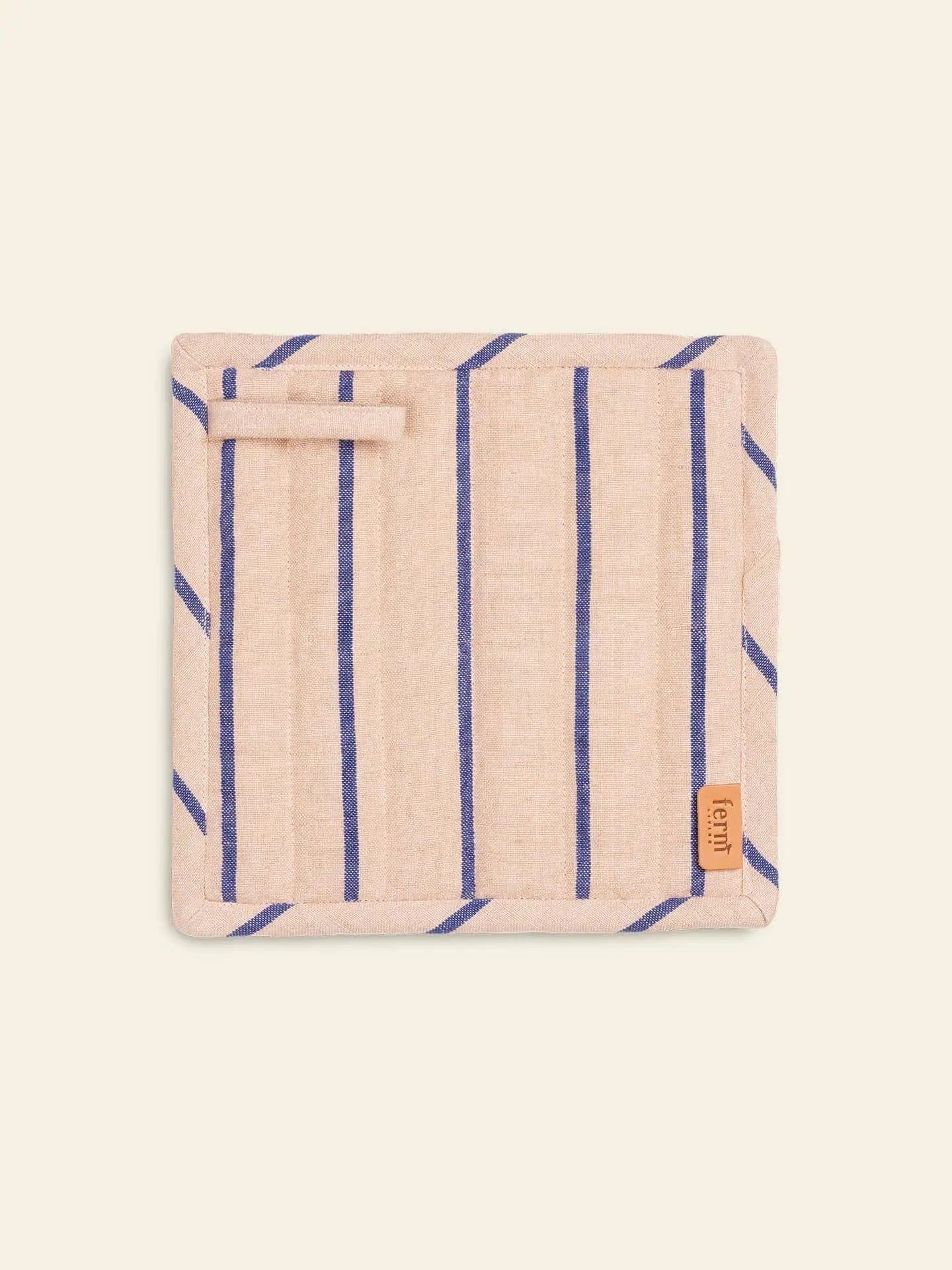 The ferm LIVING Hale Pot Holders, Set of 2, are rectangular beige holders with vertical blue stripes, a geometric print, a top left hanging loop, and a branded brown fabric tag—an elegant touch for any kitchen.