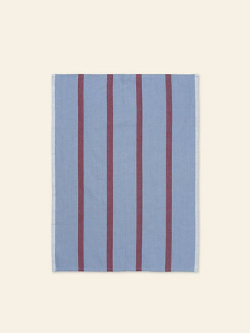 The ferm LIVING Hale Tea Towel, by ferm LIVING, is a square, light blue cloth featuring four evenly spaced vertical maroon stripes, shown on a plain cream background.