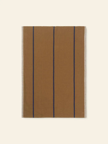 The ferm LIVING Hale Tea Towel by ferm LIVING features a rectangular brown cloth with vertical navy blue stripes and light beige side borders, displayed flat on a light beige background.