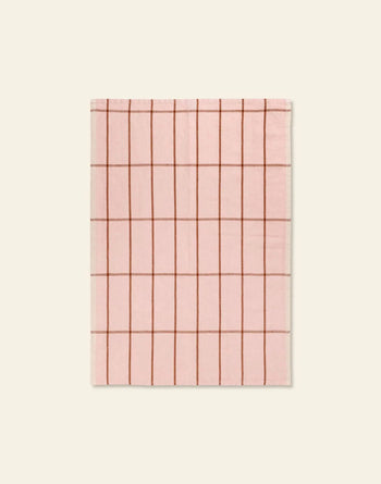 The ferm LIVING Hale Tea Towel by ferm LIVING is a pink rectangular towel featuring a grid of thin brown lines, shown flat on a beige background.