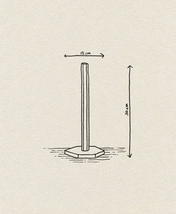 The ferm LIVING Hexagon Stand by ferm LIVING features a simple line drawing of a vertical pole with a 15 cm wide hexagonal base, standing 30 cm tall—ideal for use as a paper towel roll holder.