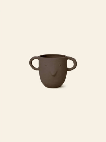 The ferm LIVING Mus Plant Pot, Large, features a brown ceramic build with two big mouse-shaped handles and a simple face design—an ideal quirky accent for your ferm LIVING-inspired space.
