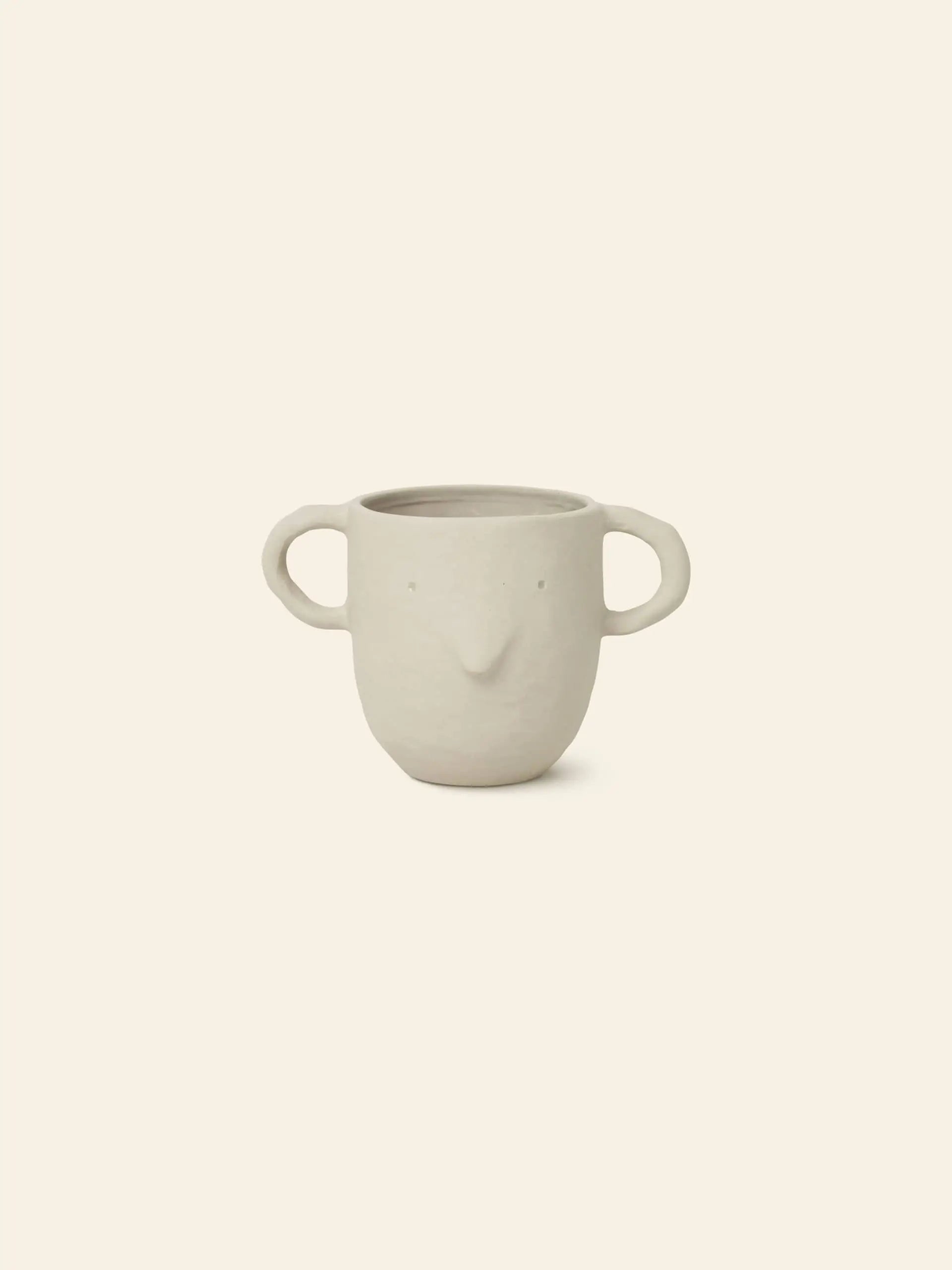 The ferm LIVING Mus Plant Pot, Large, a cream-colored ceramic piece with two large mouse handles and subtle facial features, is displayed on a plain beige background.