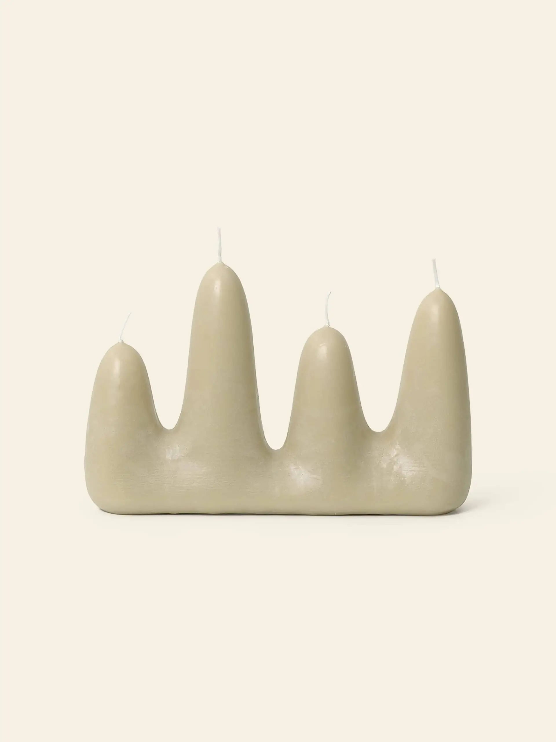 The ferm LIVING Stala Candle features four beige, rounded peaks of varying heights, each with its own wick, offering unique decor by ferm LIVING and photographed against a plain light background.