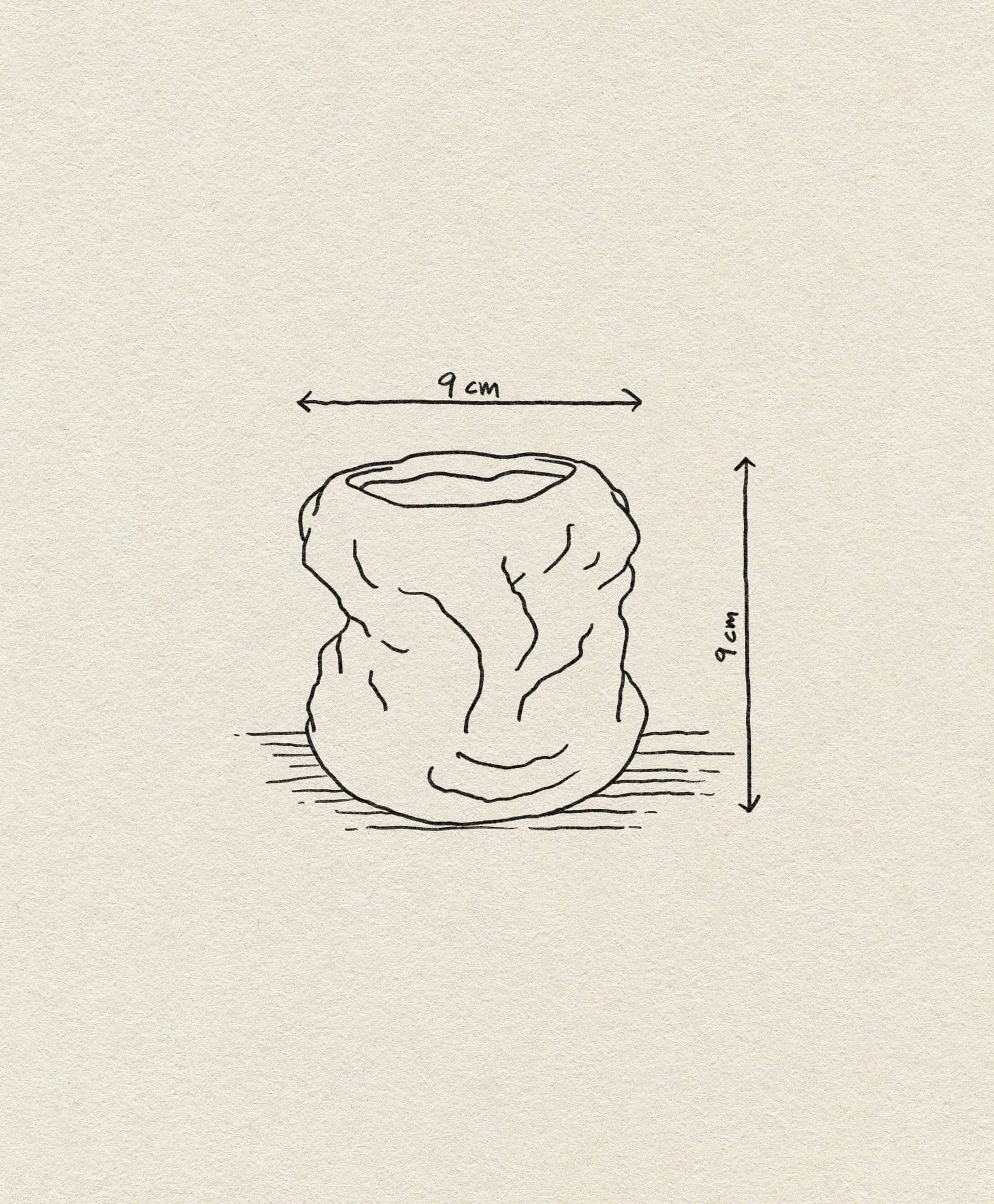 A hand-drawn illustration of the ferm LIVING Tuck Scented Candle, a crumpled round container with an open top, shows its calming ambiance. Its 9 cm height and width are labeled on a textured beige background.