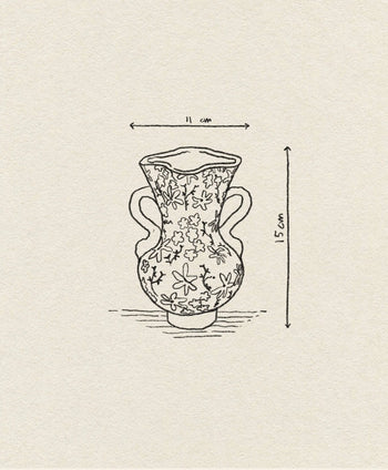 The &klevering Buttercup Vase by &klevering features petite flowers and two handles in a hand-drawn romantic style, measuring 11 cm wide and 15 cm tall, displayed on textured paper.