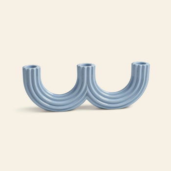 The &klevering Churros Candle Holder Light Blue by &klevering features modern, handcrafted ceramic in twin arches, forming a double U—an eye-catching decor piece for any home.