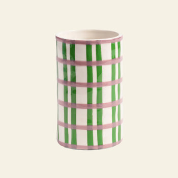 The &klevering Clash Grid Vase by &klevering features hand-painted vertical green and horizontal pink stripes in a checkered design on a white ceramic base, creating a unique and charming look.
