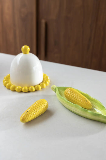 The &klevering Corn Salt & Pepper Set by &klevering—two corn-shaped ceramics on a green leaf tray—brings playful charm to your kitchen or dining table, perfect for accenting any white countertop.