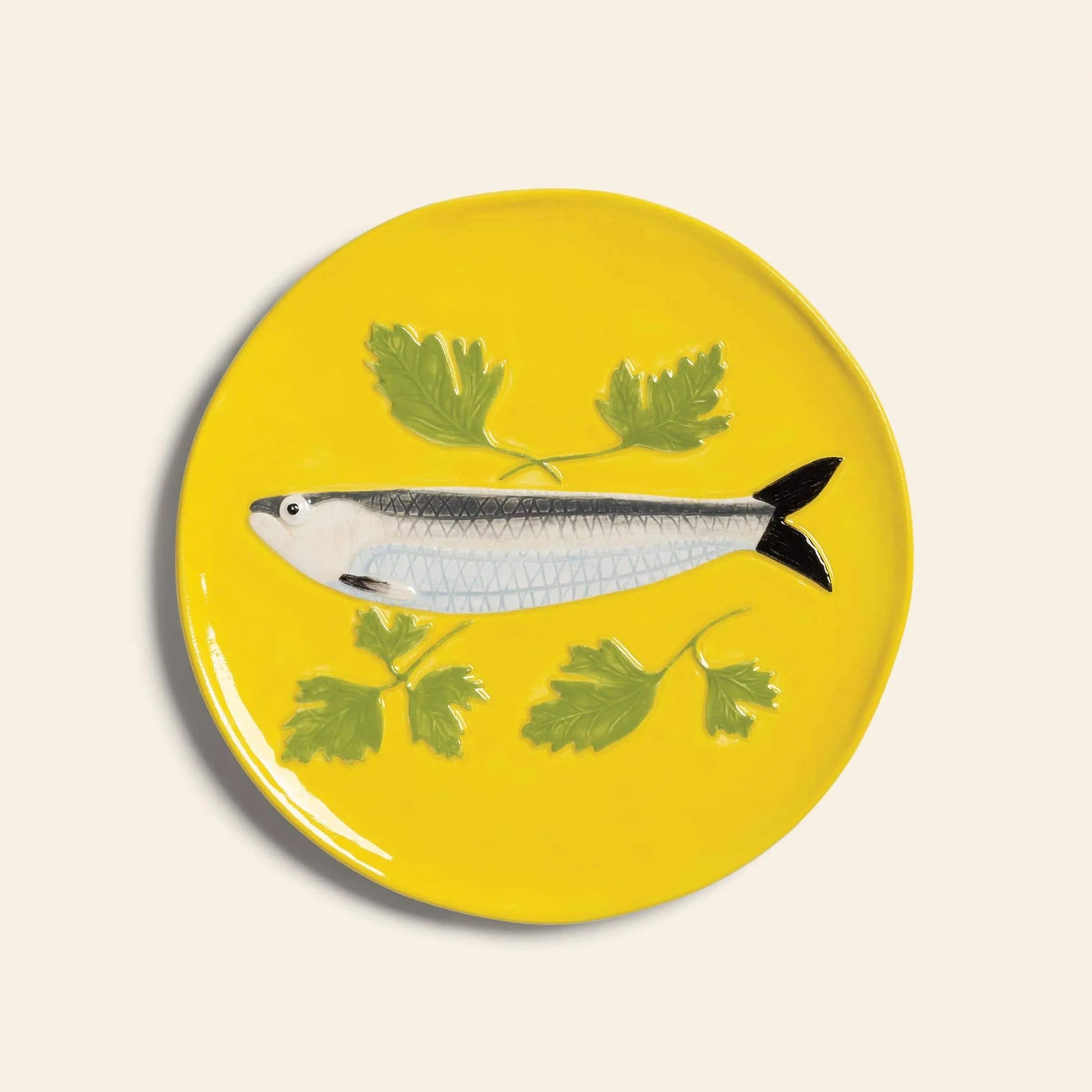 The &klevering De La Mer Plate, Set of 4 by &klevering features yellow plates with painted fish and green parsley motifs, adding ocean-inspired charm to your table on any simple light backdrop.
