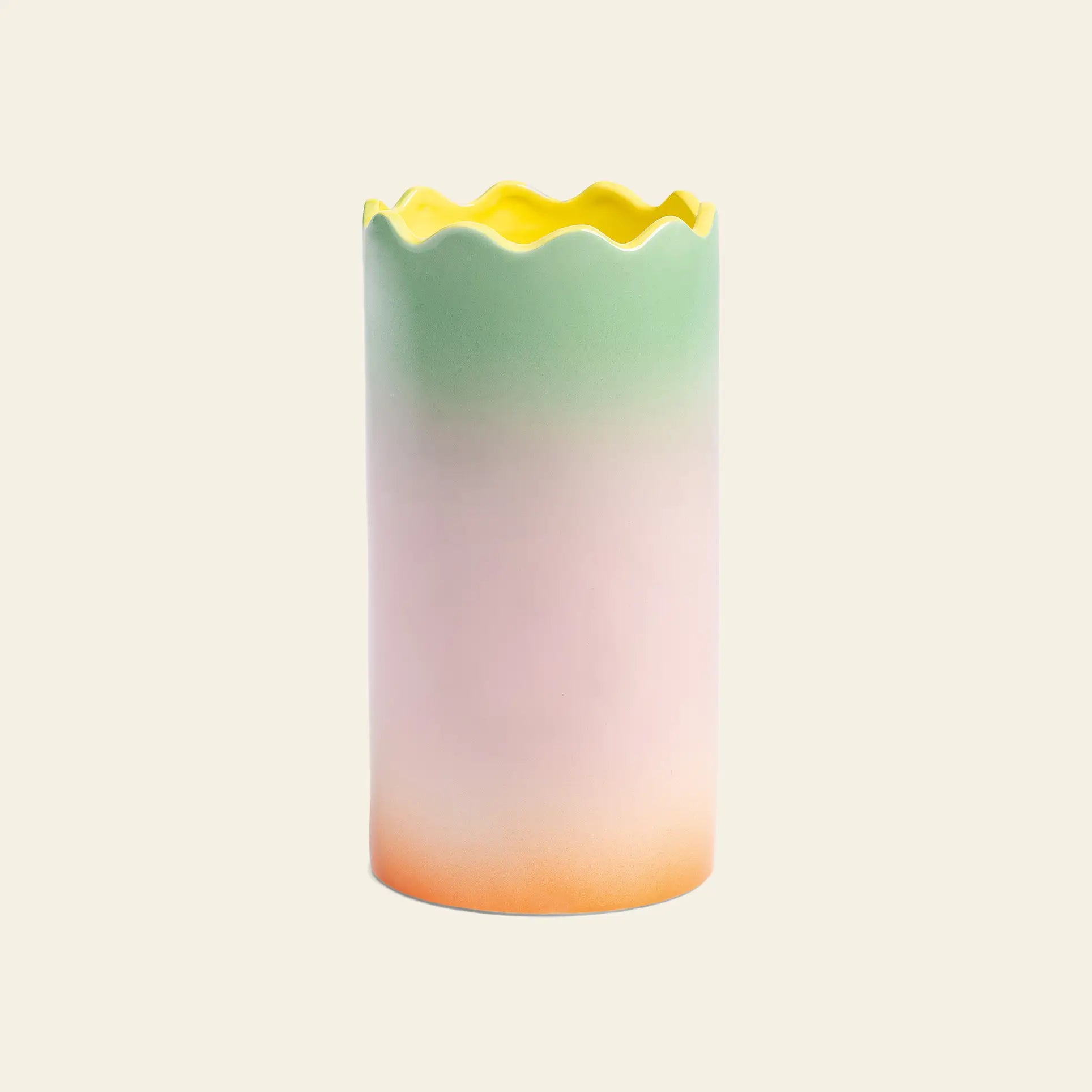 The &klevering Fade Vase, Large by &klevering is a tall ceramic vase with a wavy scalloped rim and pastel gradients—yellow at the top blending into green, pink, and orange—ideal for adding charm to any table. Shown on a plain beige background.
