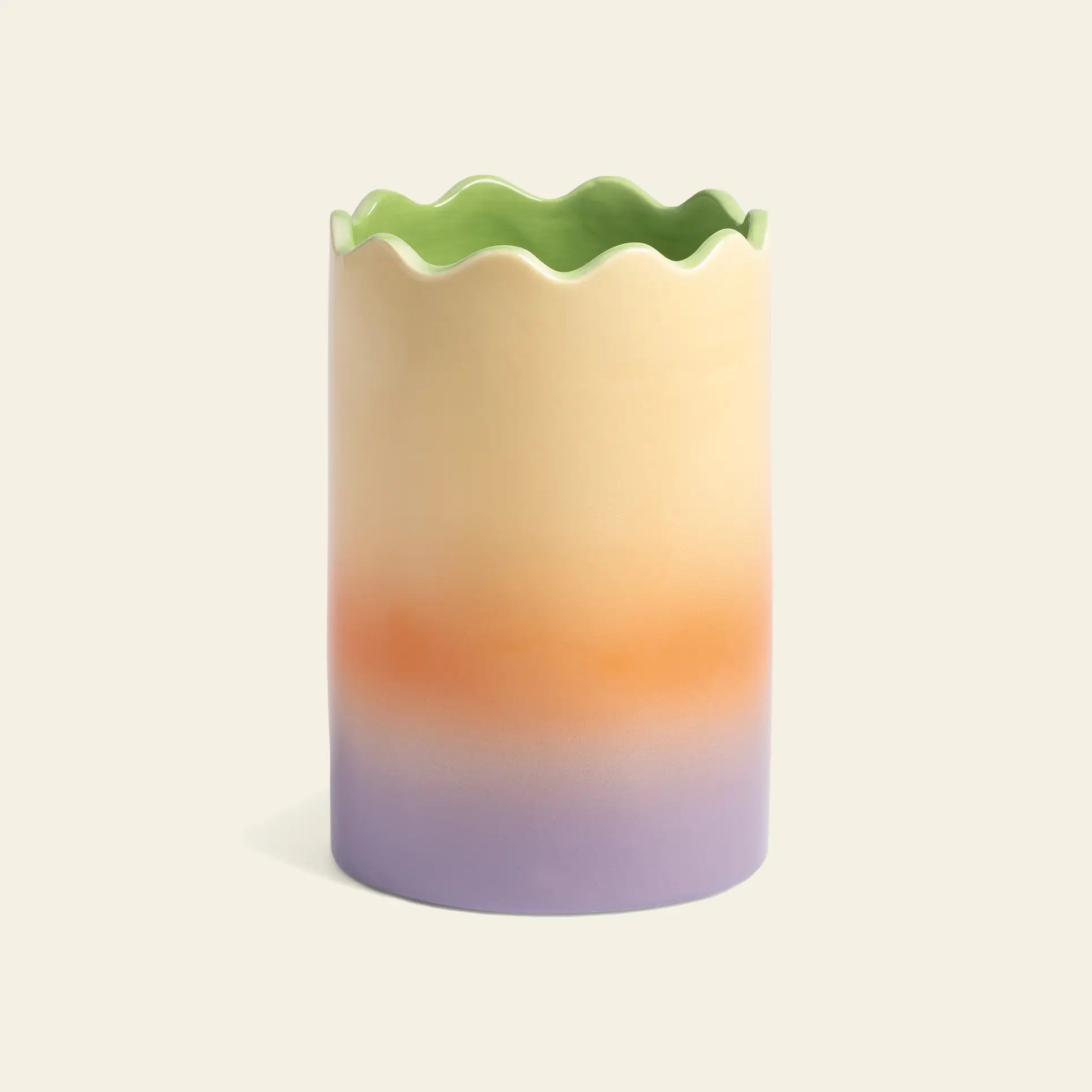The &klevering Fade Vase, Small by &klevering is a tall ceramic vase with a wavy rim and pastel gradient hues—from light green to cream, orange, and lavender—making it a perfect accent for any space. Photographed on a plain beige background.