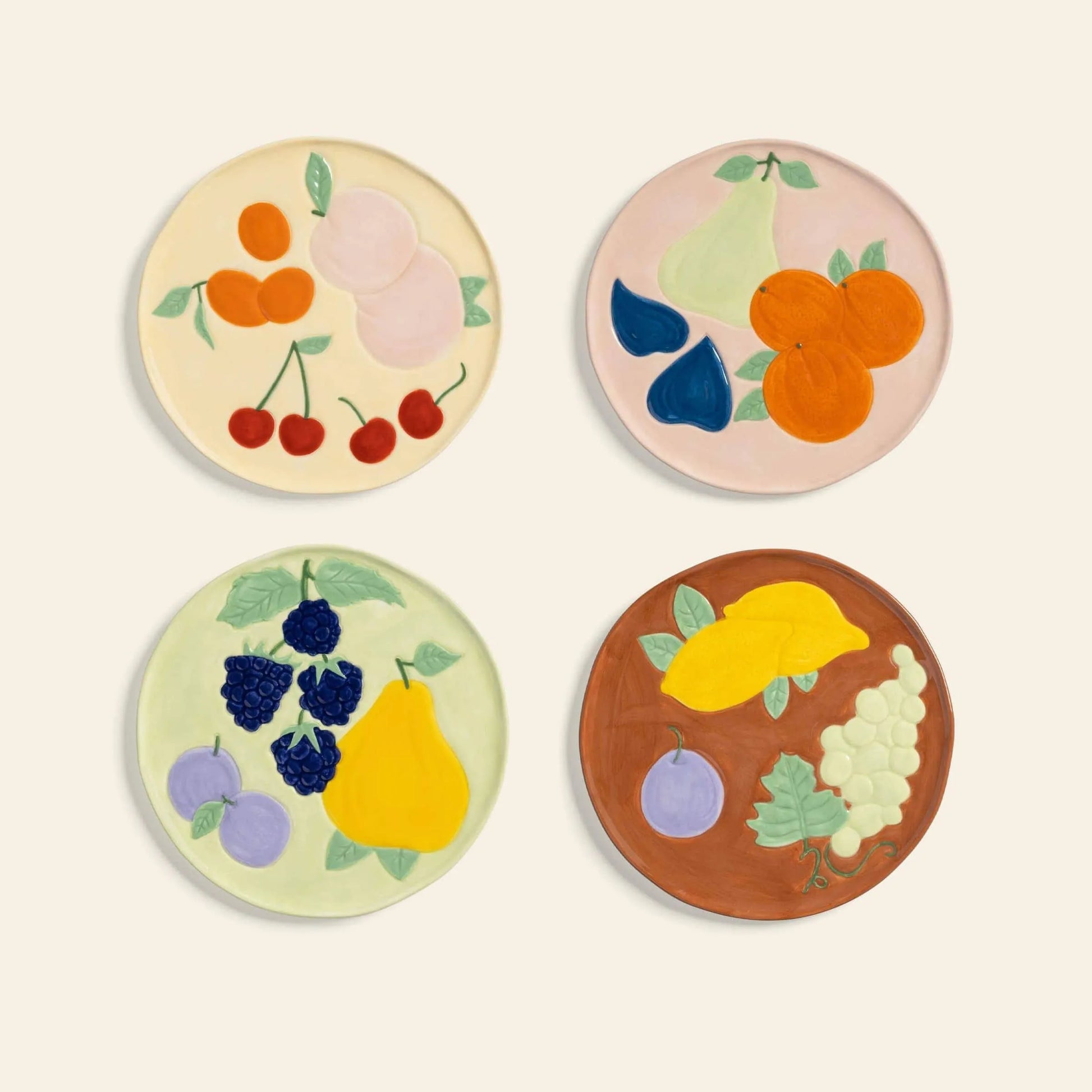 The &klevering Fruitful Plate, Set of 4, features round ceramic plates with vivid fruit motifs—cherries, peaches, figs, and more. These &klevering plates bring vintage charm to any table with their playful designs arranged on a light background.