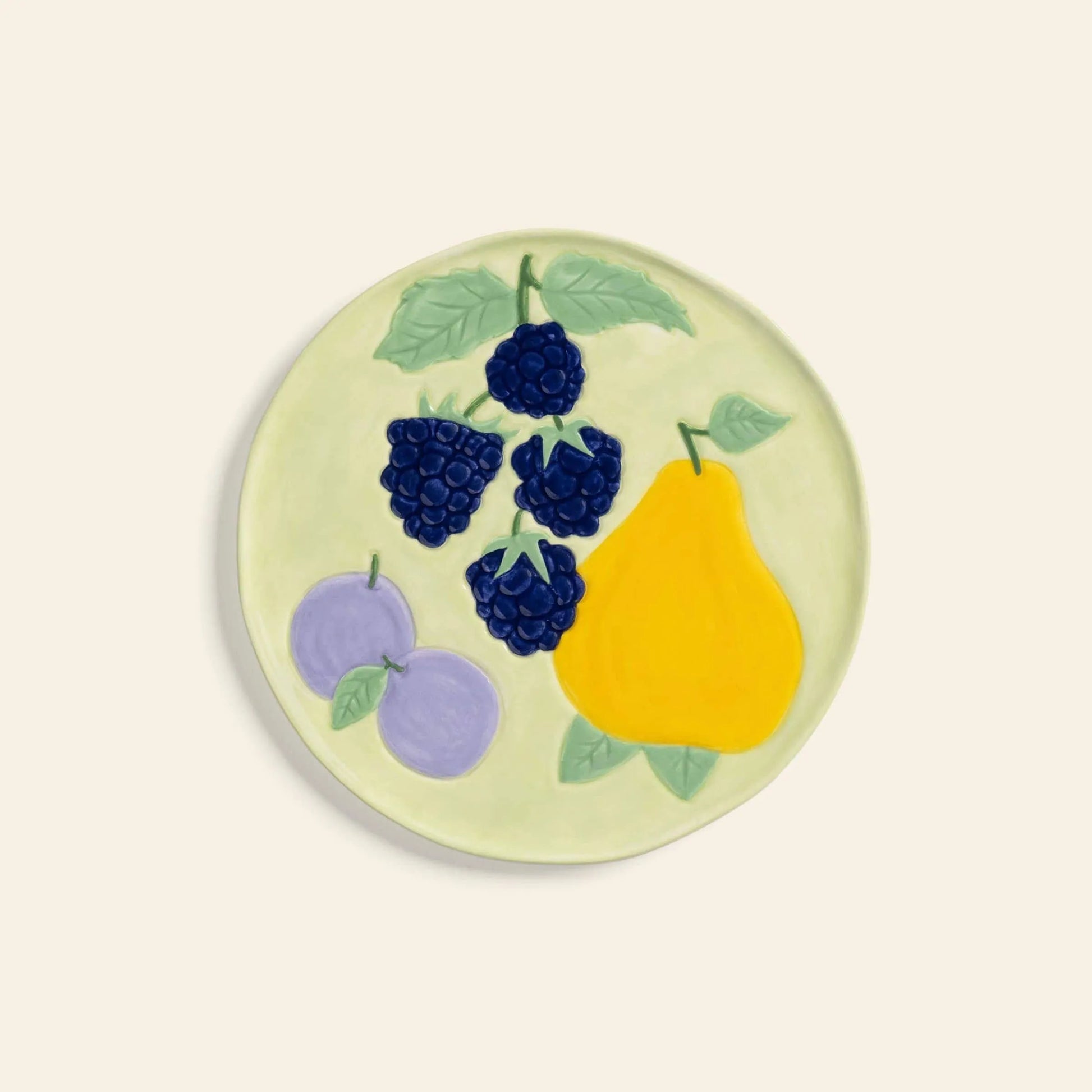 The &klevering Fruitful Plate, Set of 4, features hand-painted fruit motifs—yellow pear, purple plums with leaves, and blackberries—blending vintage charm with a light background for a stylish table setting.
