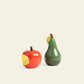 The &klevering Haines Apple Pear Salt & Pepper Set by &klevering features a glossy red apple with a yellow leaf and a green pear with a yellow leaf—stylish, fun pieces to brighten your tableware collection.