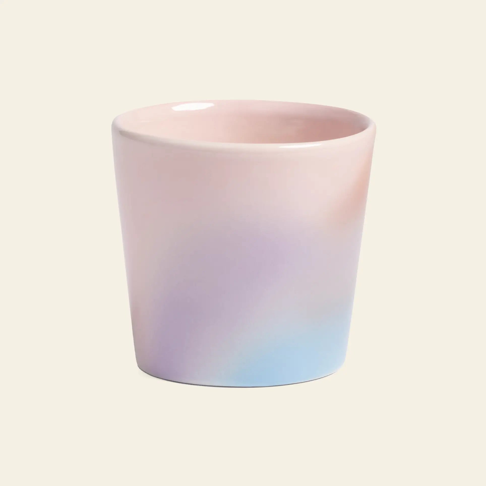 The &klevering Hue Mug Small, Set of 4 by &klevering features ceramic mugs with a smooth pastel gradient in pink, purple, and light blue tones, displayed against a plain beige background.