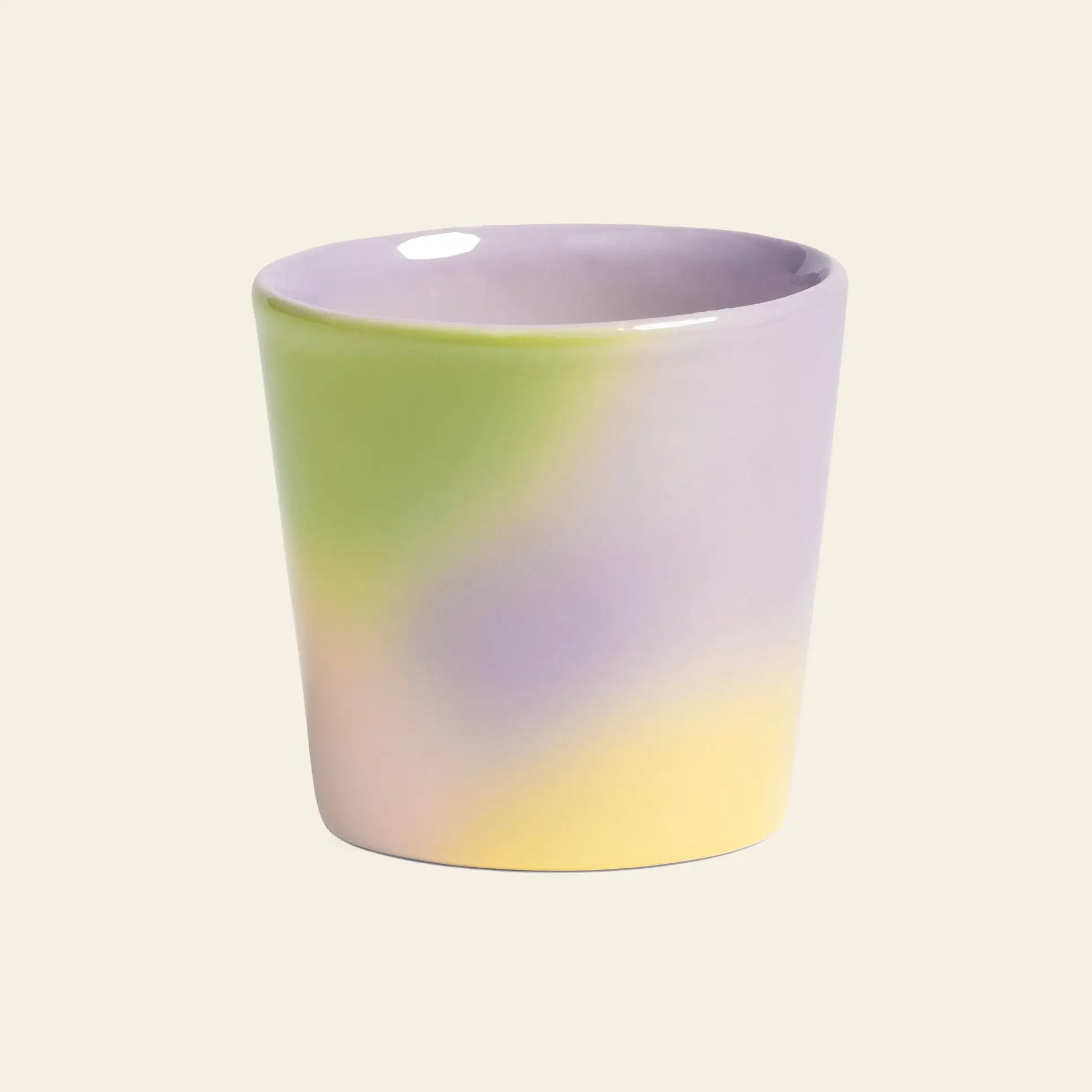 The &klevering Hue Mug Small, Set of 4, features ceramic cups in pastel green, yellow, and lavender with a smooth finish on a beige background—ideal for bringing the vibrant style of &klevering to your space.