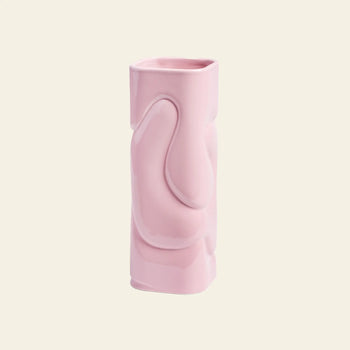 The &klevering Puffy Vase by &klevering features a glossy light pink ceramic finish and a unique hand-sculpted design, making it ideal for vibrant flower displays. Displayed against a plain off-white background.