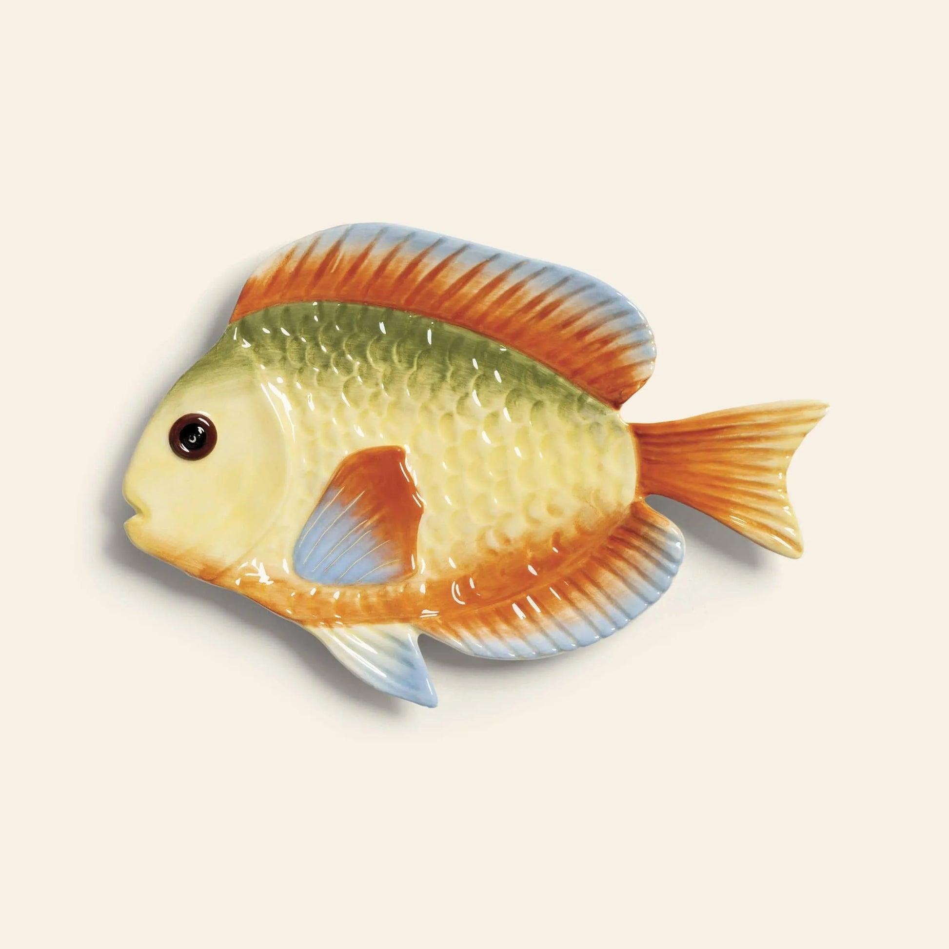 Brighten your table with the &klevering Rainbow Fish Plate by &klevering, a hand-painted dish shaped like a colorful fish featuring yellow, green, blue, and orange hues with detailed scales and fins.