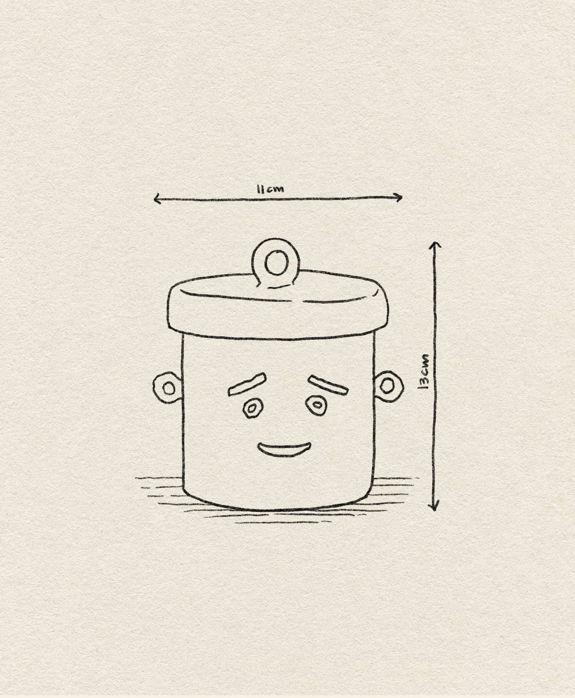 The &klevering Shy Jar by &klevering features a cute line drawing of a pot with two handles, a lid, and an adorable smile. With dimensions of 11 cm wide by 13 cm tall, it sits on light textured paper—a charming storage companion!.