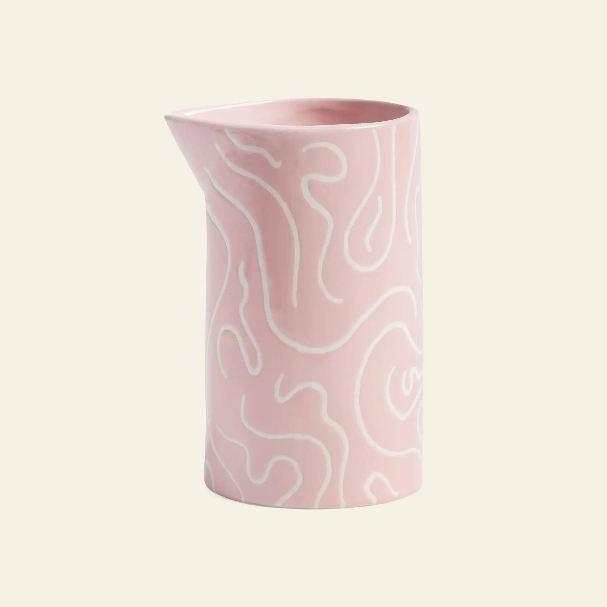 The &klevering Soba Jug is a pink ceramic jug with a glossy finish, decorated with cheerful white doodle prints and wavy abstract lines, all set against a light beige background.
