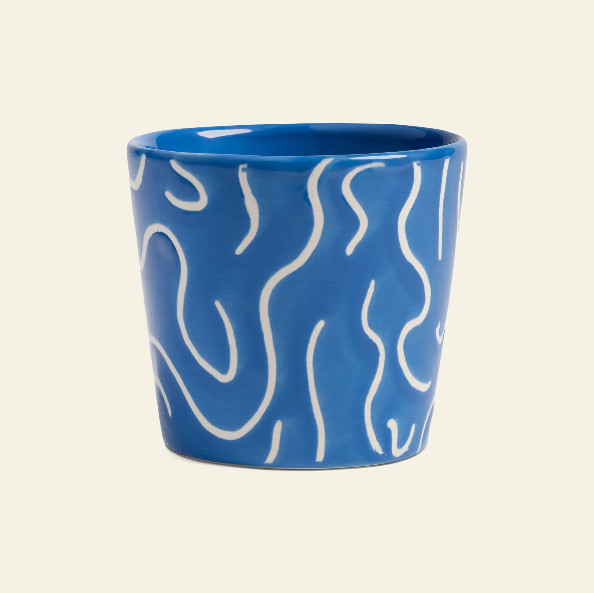 The &klevering Soba Mug Small, Set of 4, features blue ceramic mugs adorned with playful white squiggly doodle prints, standing out against a plain light background.