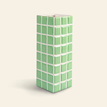 The &klevering Tiled Vase Mint by &klevering is a tall, rectangular ceramic vase featuring raised green square tiles outlined in white on a light background.