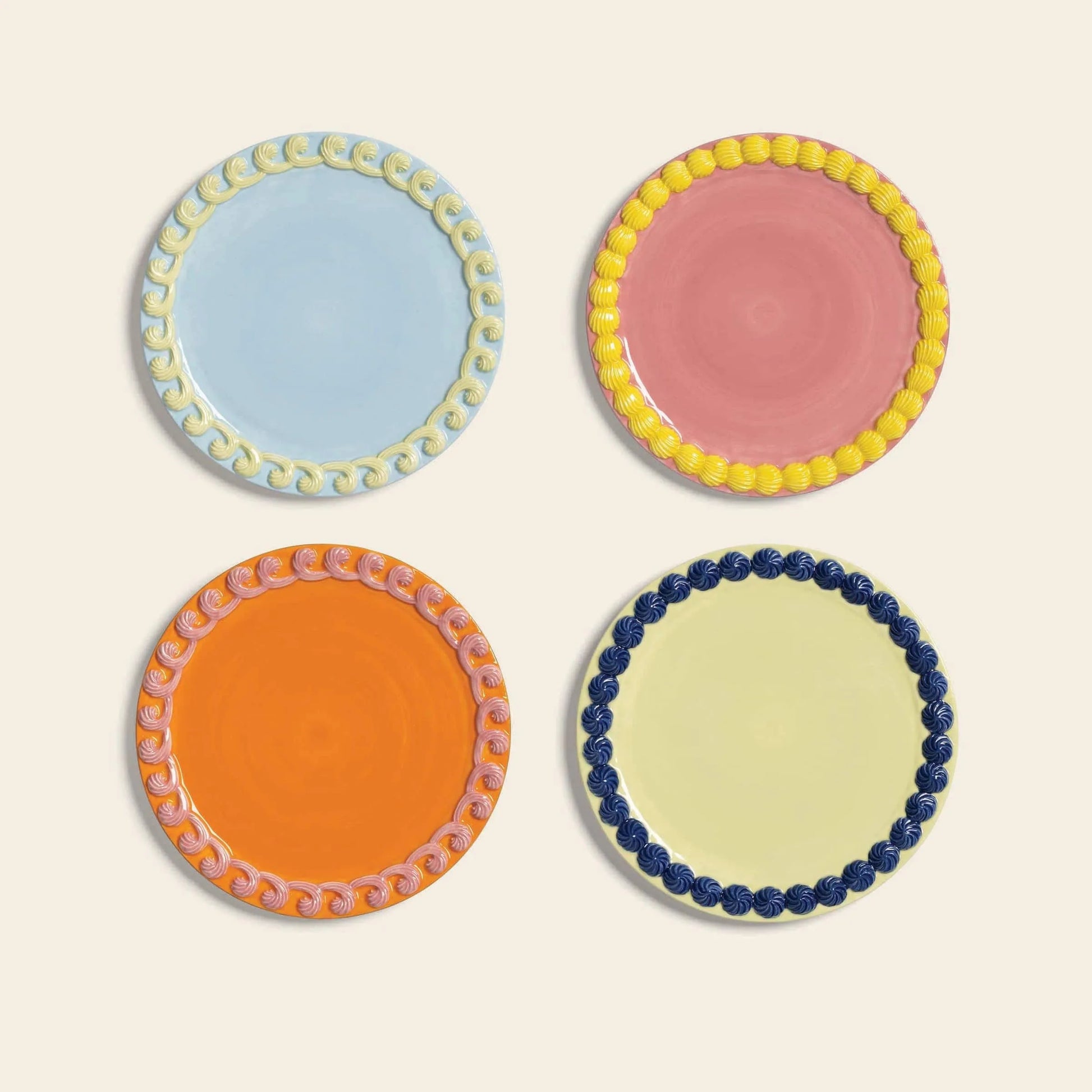 The &klevering Whipped Plate, Set of 4 by &klevering features round plates in playful candy colors with decorative borders, shown in a 2x2 grid on a light background.