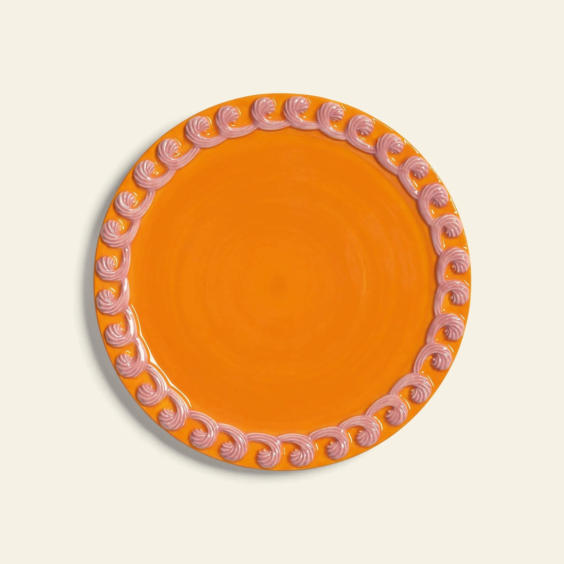 The &klevering Whipped Plate, Set of 4, features round orange plates with a decorative pink swirl candy-colored rim, from the &klevering collection, displayed against a light background.