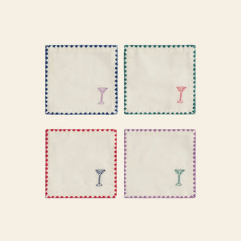 The &klevering Zigzag Cocktail Napkin Set of 4 features vibrant embroidery of cocktail glasses in each corner and colorful borders—blue, green, red, and purple—perfect for adding a stylish touch to your gatherings.