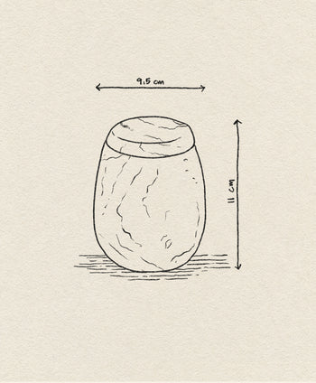 A hand-drawn sketch of the stillgoods Ecru Jar by stillgoods, oval-shaped and sized 9.5 cm wide by 11 cm tall, with horizontal and vertical arrows showing dimensions on a textured beige background.
