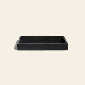 The stillgoods Mini Valor Tray, a rectangular, shallow organizer with low-profile raised edges, is ideal for keeping essentials tidy. Shown here on a plain light beige background.