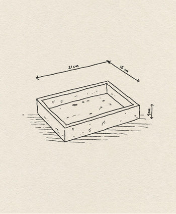 A hand-drawn sketch of the stillgoods Mini Valor Tray, a rectangular box measuring 21x15x4 cm. Its low-profile design is ideal for organizing essentials, set against a textured background.